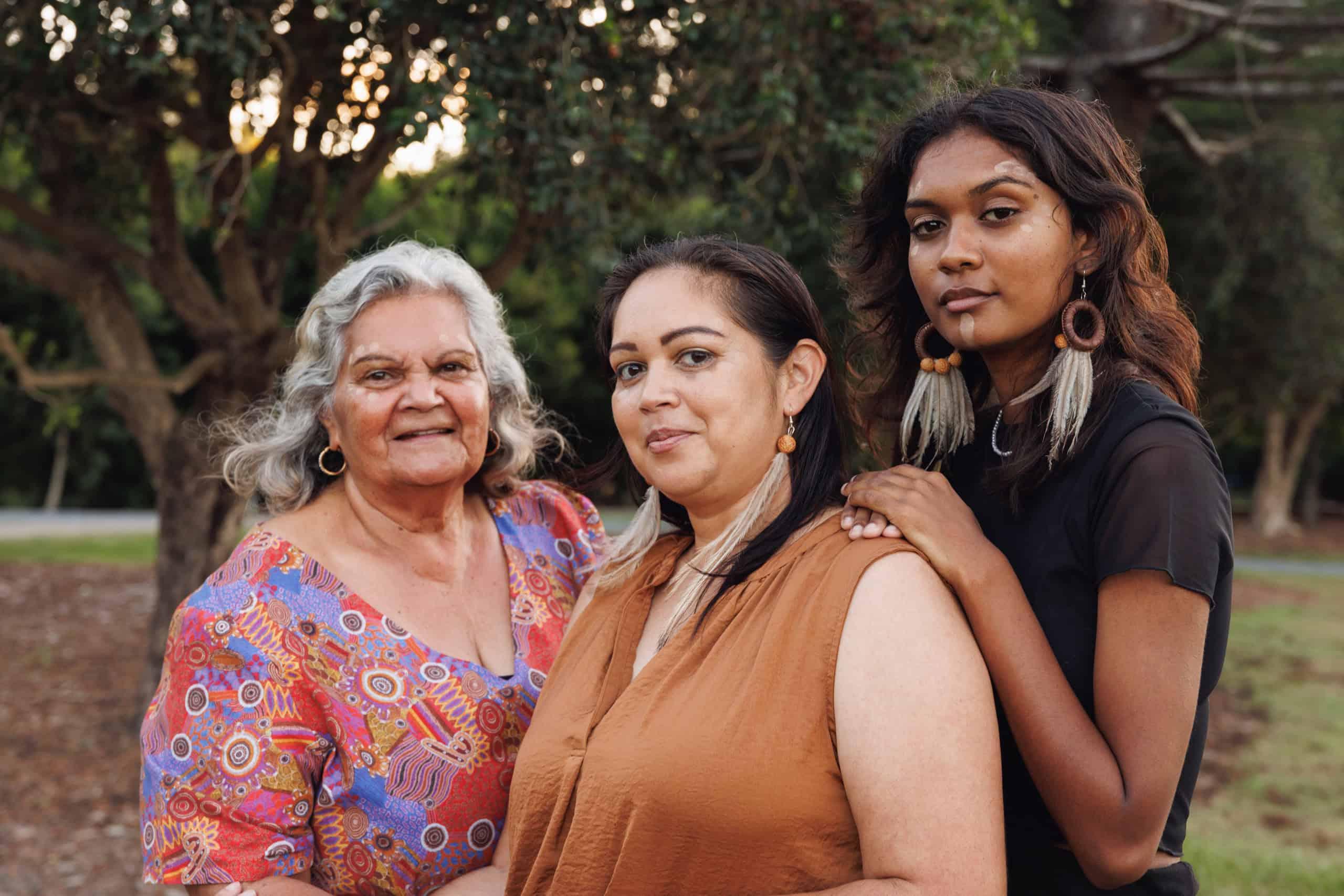 Three Aboriginal women from different generations, ideal for communicating cultural respect and community engagement within facilities operations.