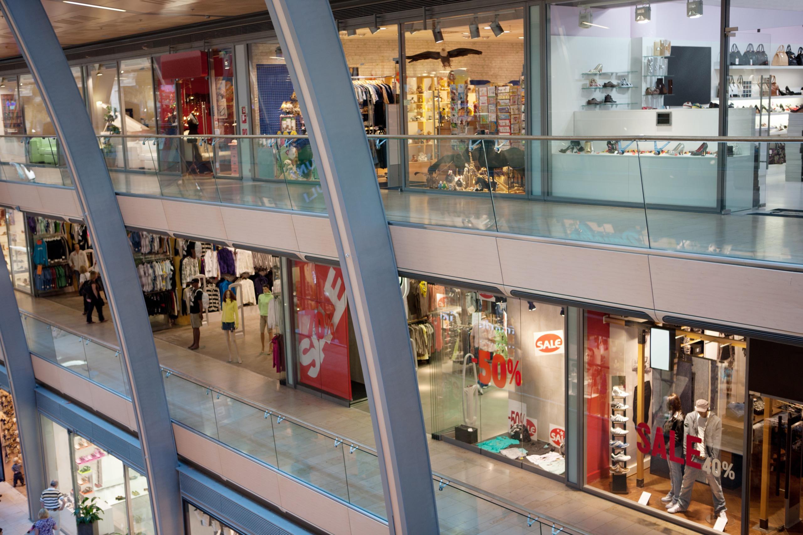 A large indoor retail shopping center with a variety of stores and bustling shoppers, focusing on maintaining operational readiness in commercial spaces.