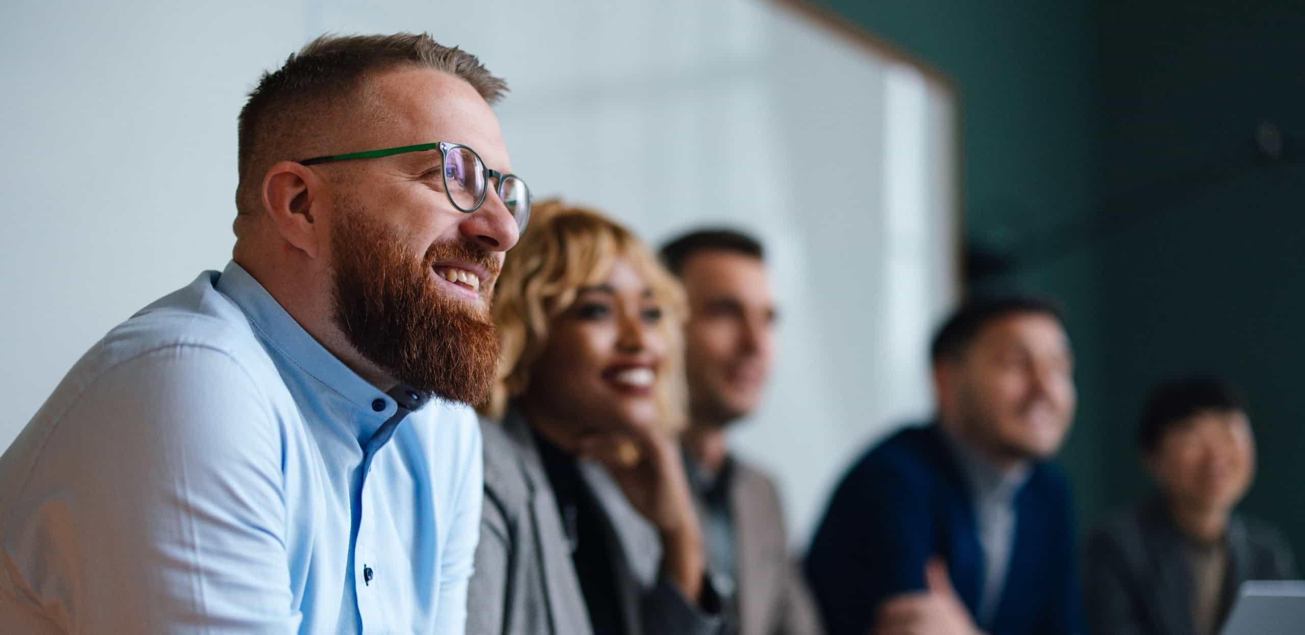 Team of professionals engaged in a meeting or training session, representing workforce development and stakeholder collaboration in facilities strategy.